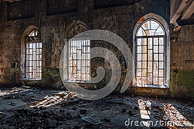 Old broken lancet windows inside abandoned building Stock Photo