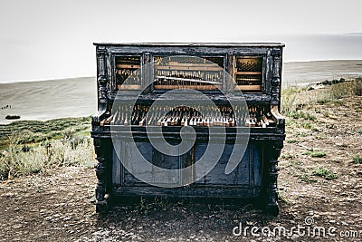 Old broken piano. Piano on beach Stock Photo