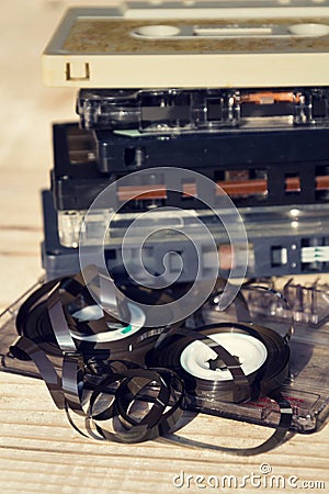 Old broken unwound compact cassette audio tape messed up on wooden background Stock Photo