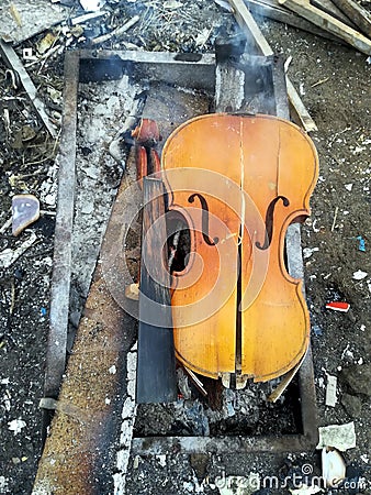 old broken violin is used as firewood Stock Photo