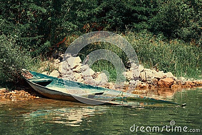 Old broken wooden boat drowned under water close to the coast Stock Photo