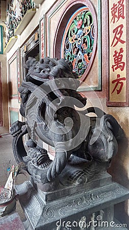 Old Bronz lion the guardian of a Chinese shrine in Tarad Noi community on Chaopraya River side in Bangkok Stock Photo