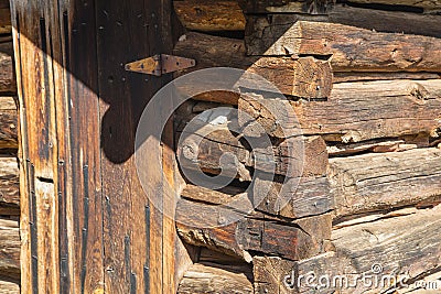 Old brown log building wall corner door background Stock Photo