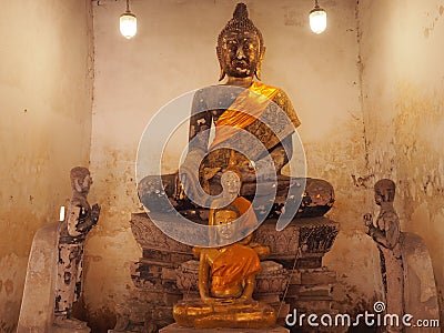 Old Buddha statue with disciple in old temple Thailand Stock Photo