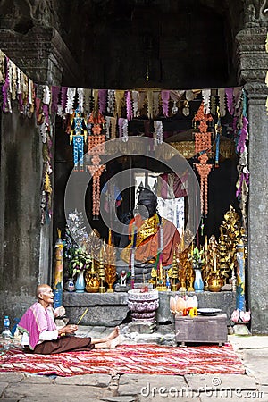 Old buddhist monk inside temple Editorial Stock Photo