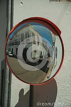 OlÃ¡ Old building on empty alley corner reflected in street mirror Stock Photo