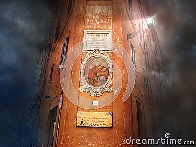 Old building with icon on a orange wall at dark mystical night. Rome, Italy Editorial Stock Photo