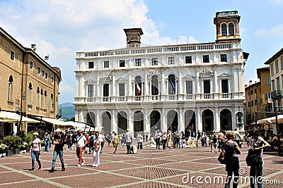 Italy, Bergamo - view on the New Palace at the Piazza Vecchio crowded with tourists Editorial Stock Photo