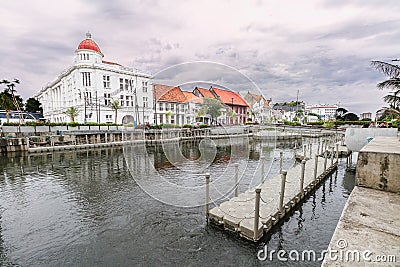 Old buildings at the side of Kali Besar River with cloudy sky at the background, Old City Tourism Area / Kawasan Wisata Kota Tua. Editorial Stock Photo
