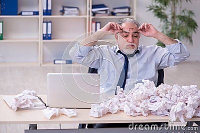 Old businessman rejecting new ideas with lots of papers Stock Photo