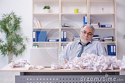 Old businessman rejecting new ideas with lots of papers Stock Photo
