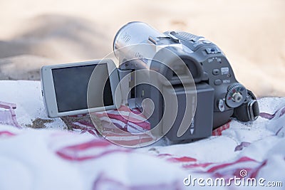 Old camera on the beach on a summer day Stock Photo