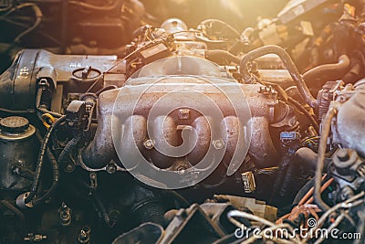 Old car engine spare part used closeup exhaust manifold or headers steel vehicle machine dirty grease grunge with oil in garage Stock Photo