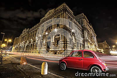 Old car Italian red by night. Italian historic monument Stock Photo