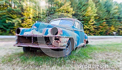 Old car wreck on a field Stock Photo