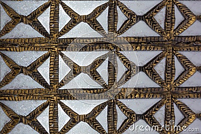 Old Carved wooden latticework with flowers and squares design creating a perforated wall Stock Photo