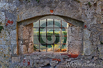 Old castle barred window with view to fall landscape Stock Photo