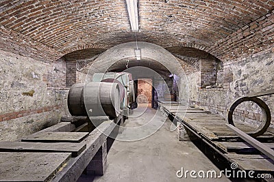 Old cellar with wooden barrels and brick ceiling Stock Photo