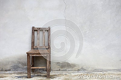 Old chair against old wall Stock Photo