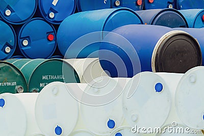 Old chemical barrels. Stack of methanol or methyl alcohol drum. Steel chemical tank. Toxic waste. Plastic and steel chemical Stock Photo