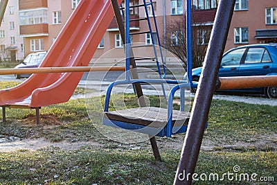 Old children`s swing in the courtyard closeup Stock Photo