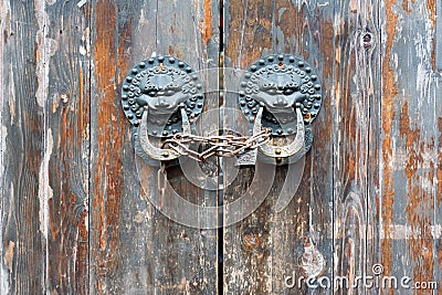 Old chinese traditional wooden gate with Lion door knockers Editorial Stock Photo