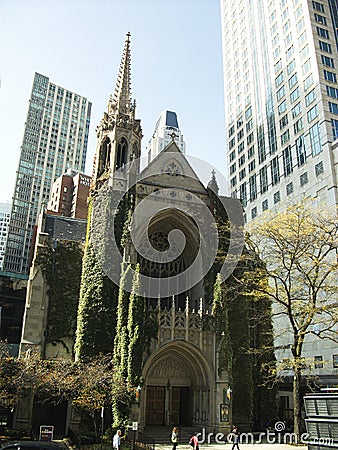 a old church in the city with skyscrapers around Stock Photo