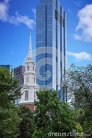 Old Church by Modern Blue Tower Stock Photo