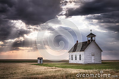 An old church on the prairie under a stormy sky Stock Photo