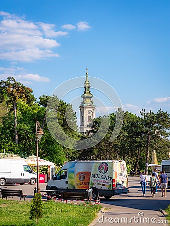 Old church tower in downtown Belgrade with a minibus in the background Editorial Stock Photo