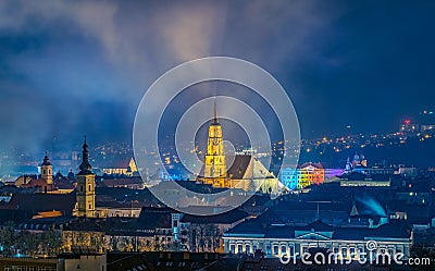 The old city of Cluj-Napoca with the Franciscan Church and St. Michael`s Church viewed from Cetatuia Park at night in Cluj-Napoca Stock Photo