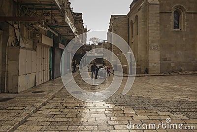 Old City of Jerusalem - Christian Quarter, empty street and square in the morning in rainy weather. Israel Editorial Stock Photo