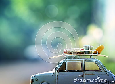Old classic retro car with surf board and beach tool on roof ag Stock Photo