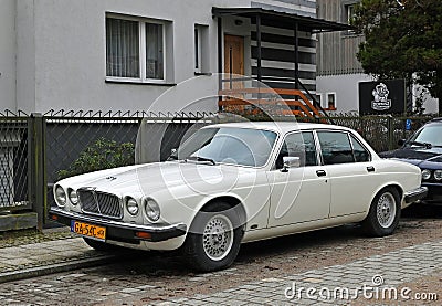 Old classic veteran ebony white Jaguar V12 Sovereign sedan executive parked Editorial Stock Photo