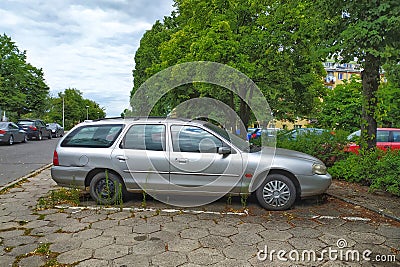 Old classic scrap rusty veteran hatchback car silver grey Ford Mondeo parked Editorial Stock Photo