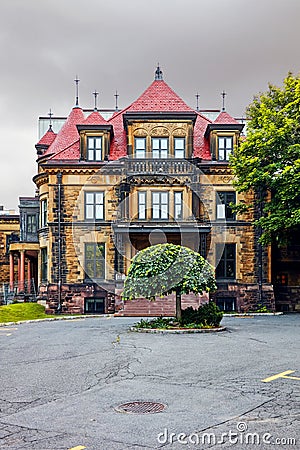Old classy historical victorian house facade with stone wall in Montreal, Quebec, Canada Editorial Stock Photo