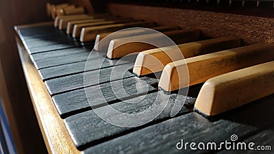 Old classy wooden musical instrument keyboard closeup, pipe organ manual, keys macro, dramatic high contrast lighting Stock Photo