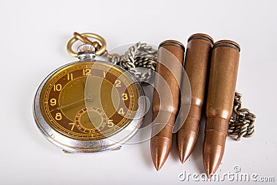 Old clock and ammunition on a white table. Explosive material and time measure Stock Photo