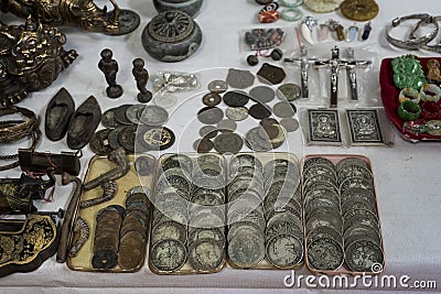 Old coins and metallic vintage objects presented on an antics market`s table Editorial Stock Photo