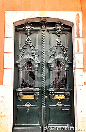 Old and colorful carved wood door with iron details Stock Photo