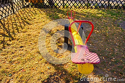 Old colorful seesaw in a playground during daytime Stock Photo