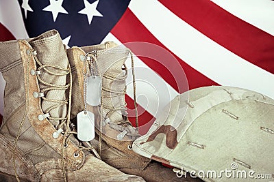 Old combat boots, dog tags, and helmet with American flag Stock Photo