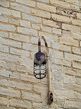 Old commercial light fixture on a brick building Stock Photo