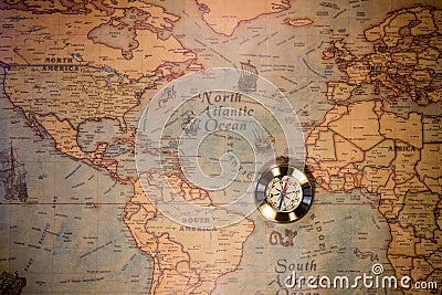 Old compass on vintage map. Adventure stories background. Stock Photo