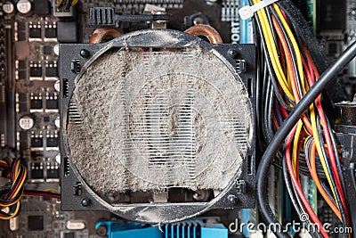 Old computer system unit cooler with dust inside. Dust on the computer pc processor cooler with computer case fragment Stock Photo