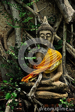 Old concrete buddhist sculpture in meditation action Stock Photo