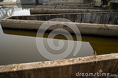 Old concrete structure of irrigation control system with water inside. Stock Photo