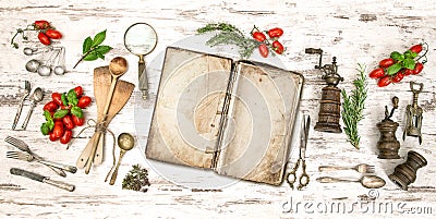 Old cookbook with vegetables, herbs and vintage kitchen utensils Stock Photo