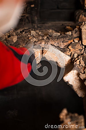 Old cooking stove, brick in soot, stove in the form of an arch, dismantling of the stove. Stock Photo