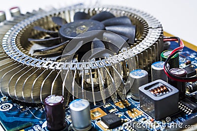Old cooler from the computer. Motherboard of blue color. Repair of the personal computer. Modern technologies. Workshop. Stock Photo